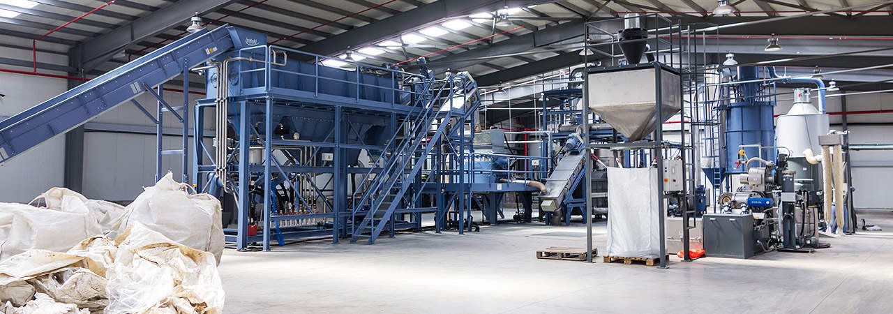 Herbold plastic washing line installed in a recycling plant, with conveyors and storage silos