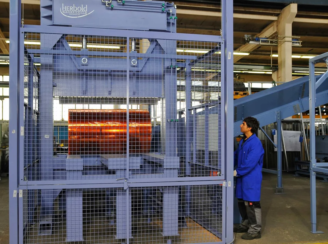 Compacted film bale positioned under the cutting blade